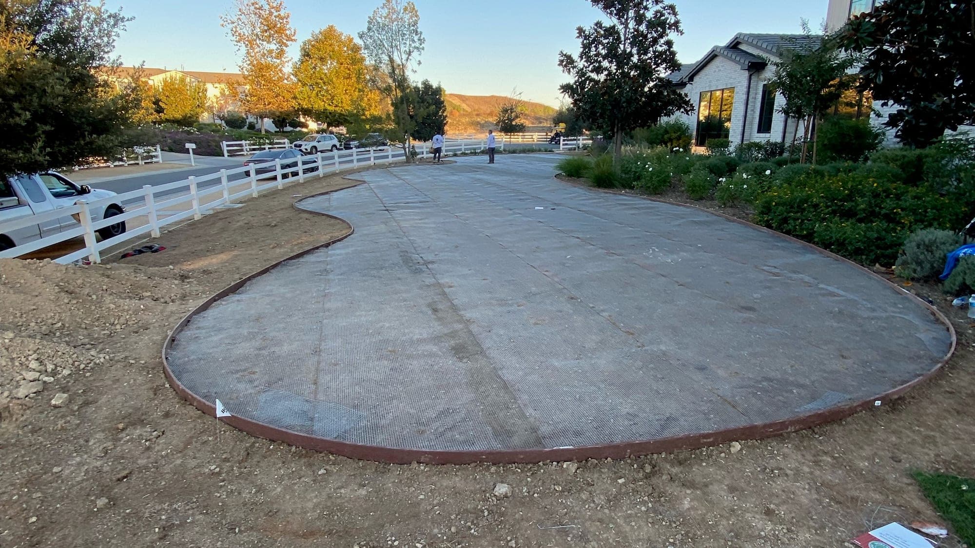 Same backyard before installation, showing bare dirt and concrete
